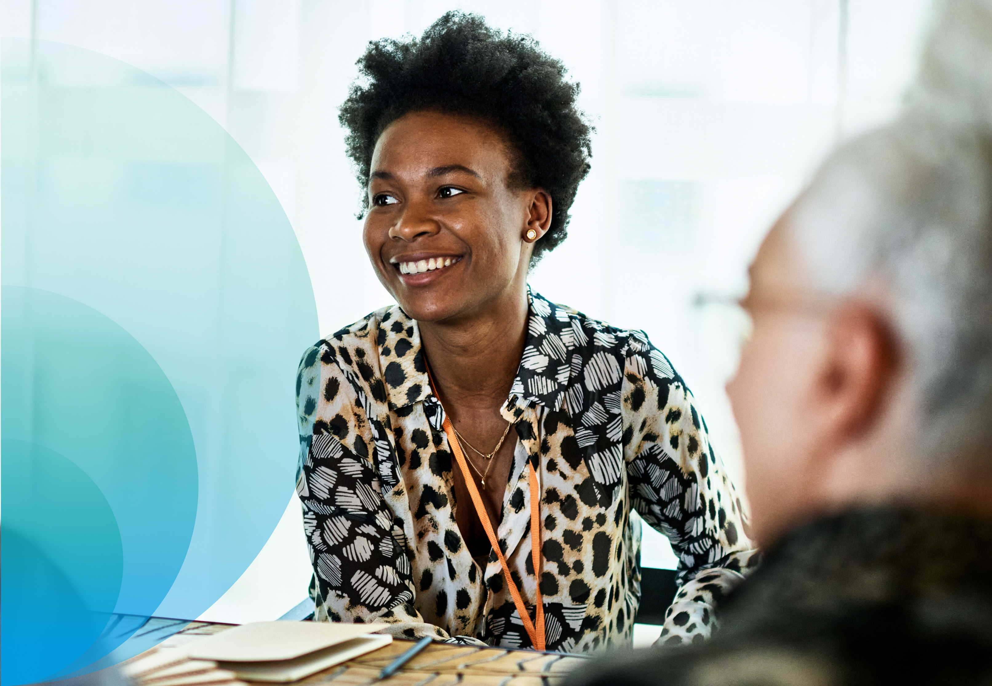 Partner Hero - A woman smiles during a meeting