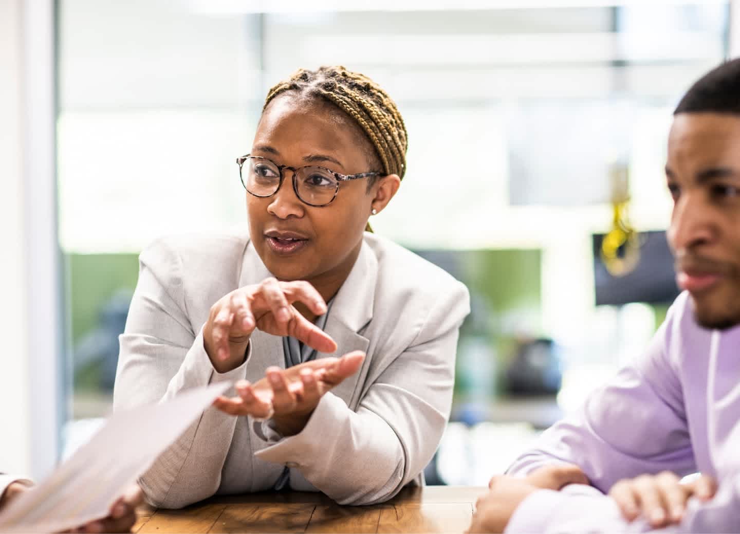 A woman explains a concept during a business meeting